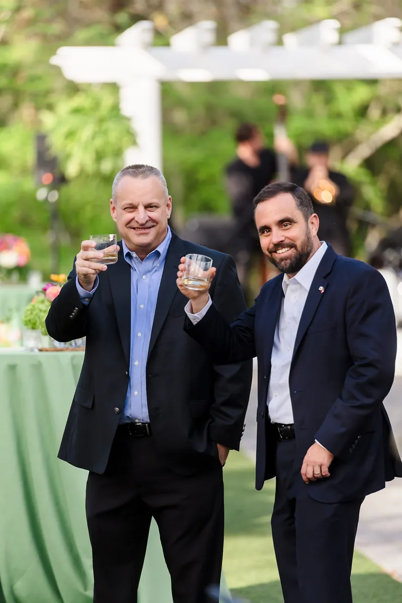 Two conference guests laughing on a terrace